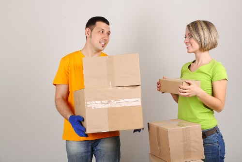 Professional movers loading furniture into a van in Barbican